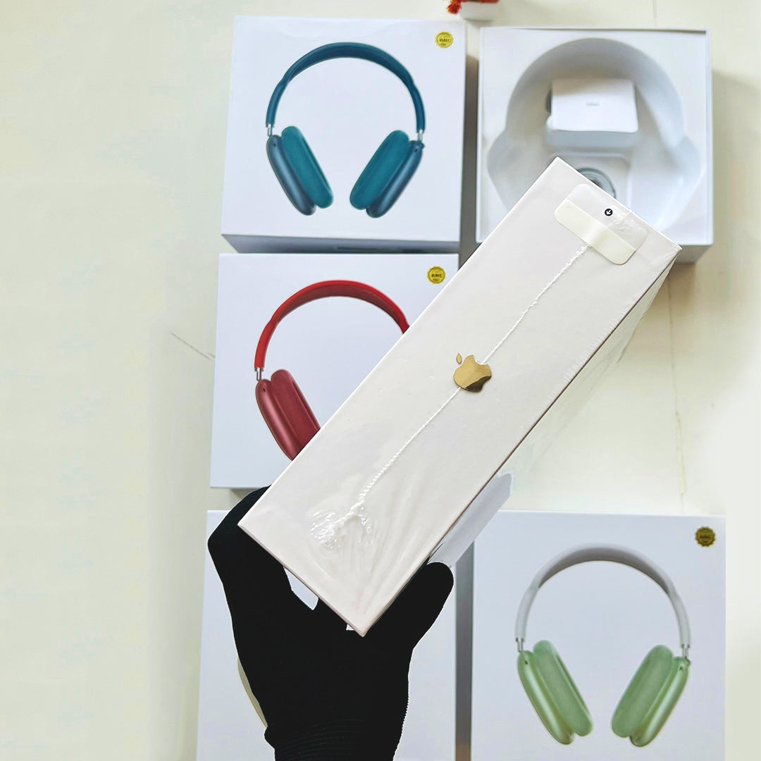 White box with a gold emblem held by a hand, with colorful headphones in the background