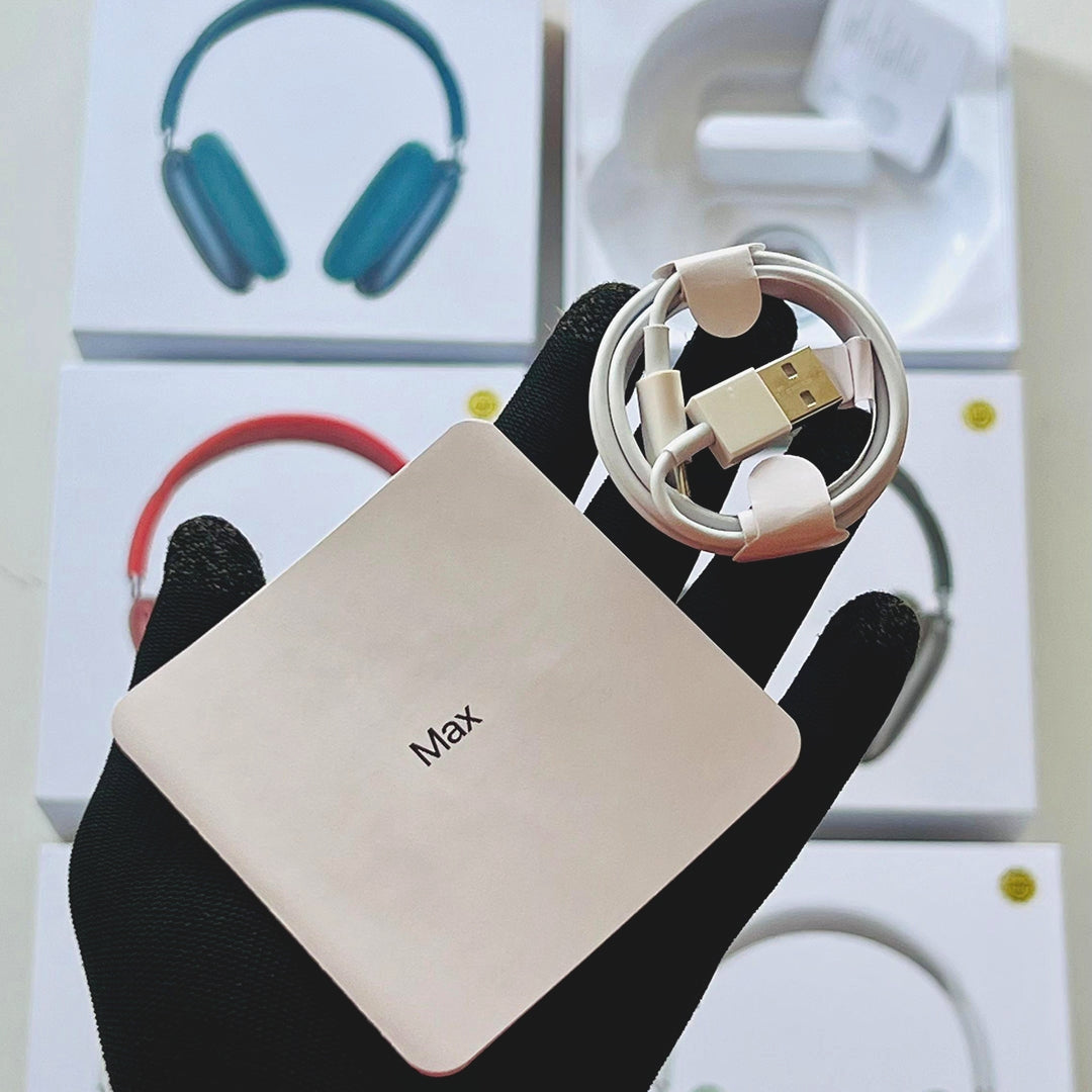  The AdiStore Adi Max (ANC) headphones with 'Adi Max' branding held by a black glove, with headphones in the background.