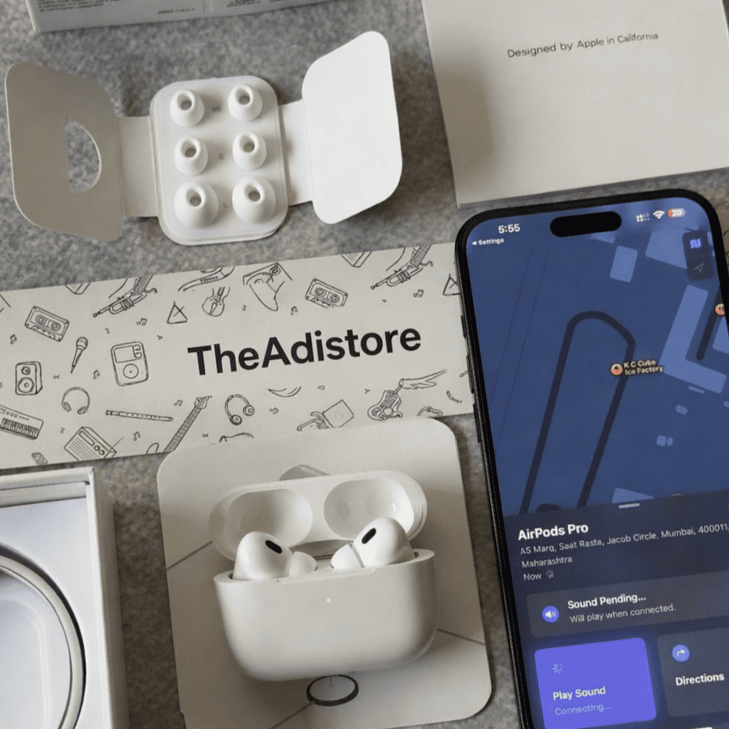 Adipods Pro 2 in charging case with smartphone displaying Adipods Pro 2 on screen, on a branded mat.