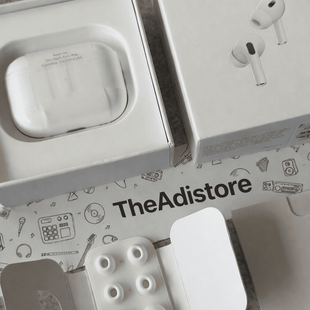 White wireless earbuds with charging case on a branded box from TheAdistore.