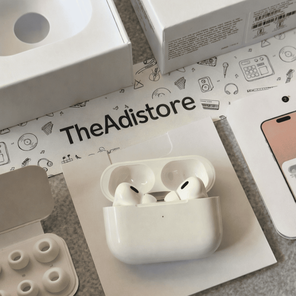 White wireless earbuds in a charging case on a branded surface with 'TheAdistore' branding.