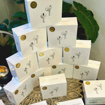 Multiple boxes of Adipods Pro 3 wireless earbuds stacked on a surface with green plants in the background.