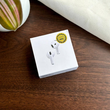 White Adipods Pro 4 earbud packaging with a gold badge on a wooden surface