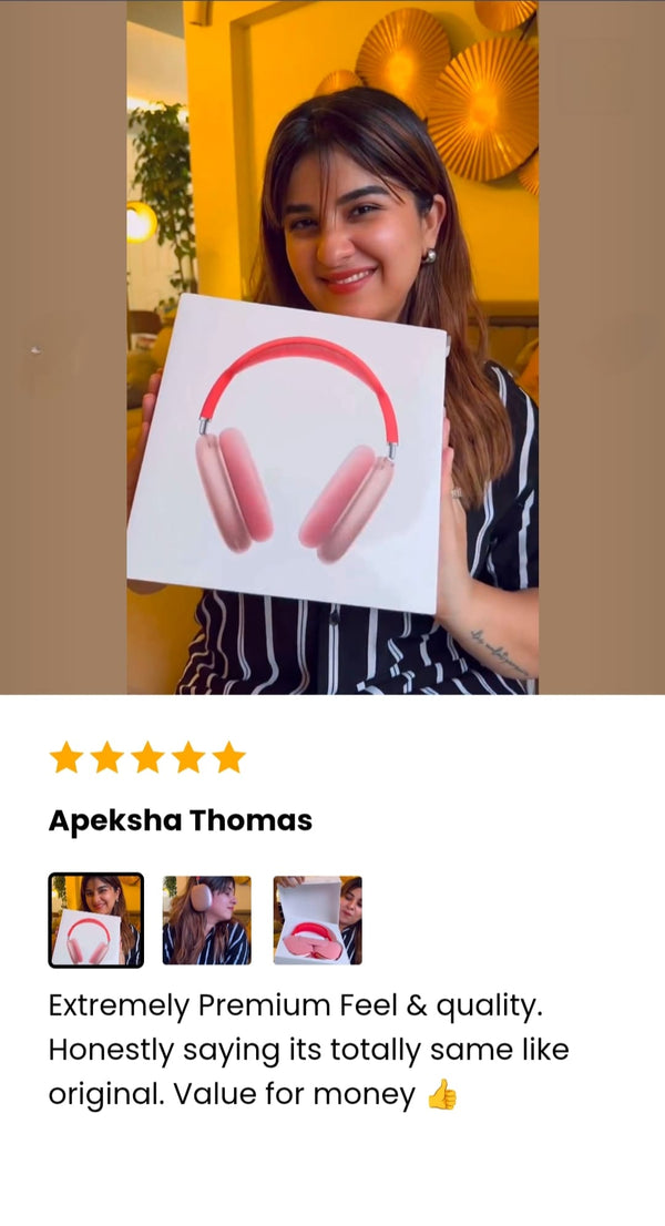 Person holding a The AdiStore Adi Max (ANC) pink headphones on it, with a yellow wall and decorative elements in the background.